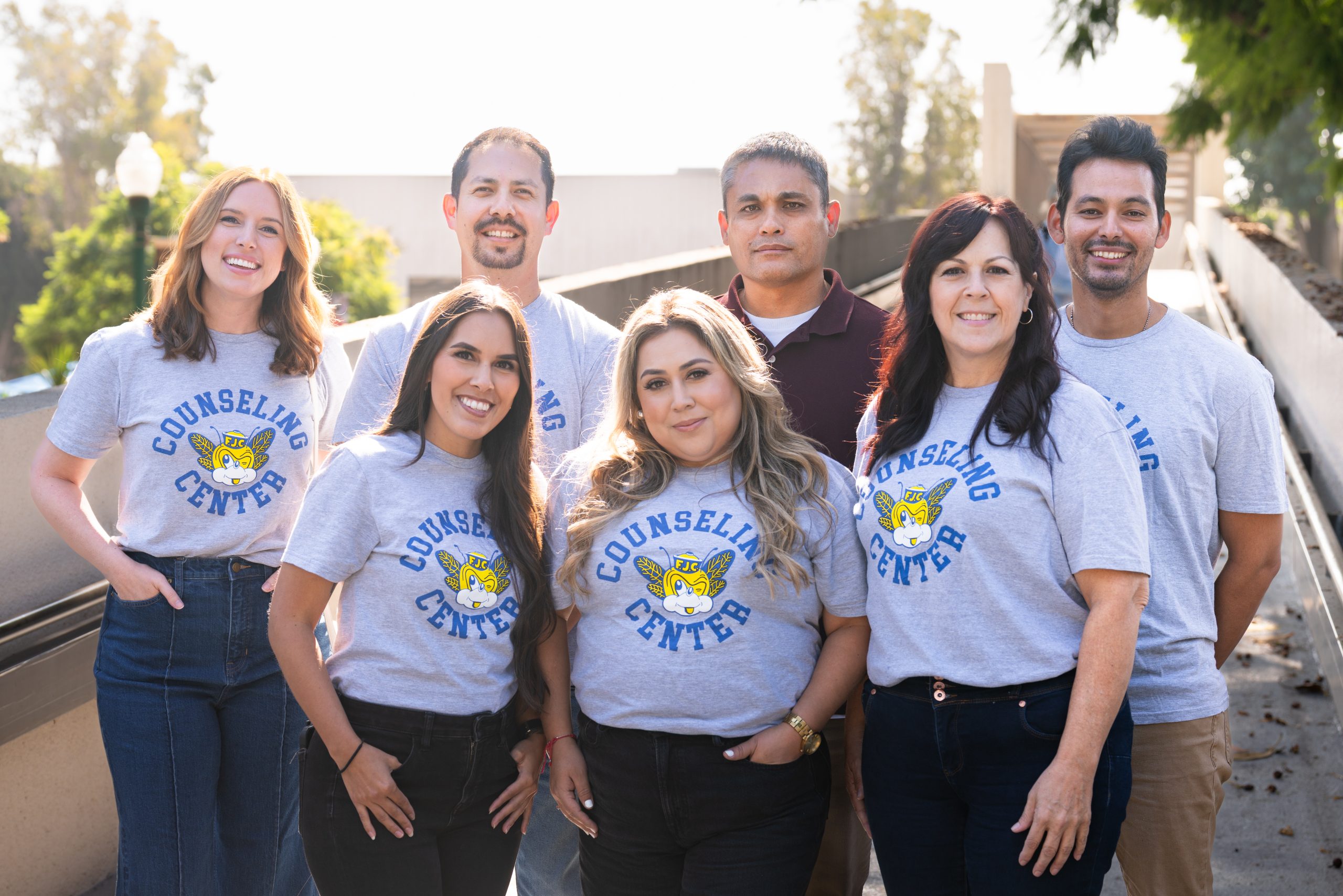 Group of Counselors smiling on the Fullerton College bridge