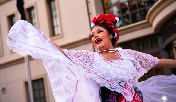 Girl getting face painted on Dia de los Muertos