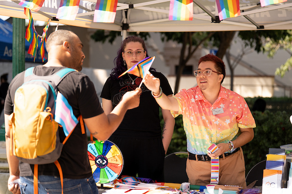 Staff member handing a student a pride flag